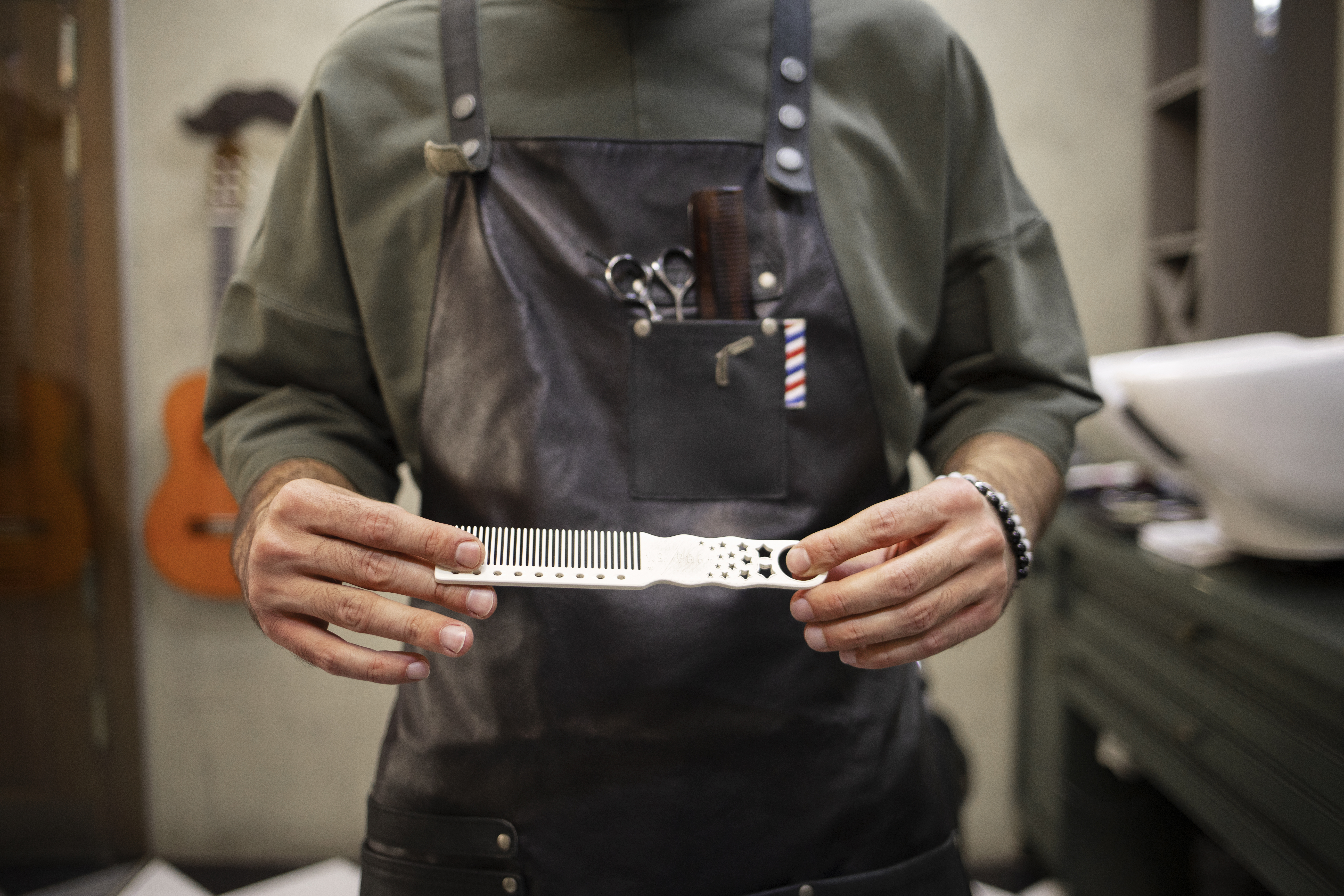 male barber sitting his shop